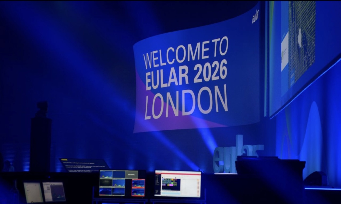 Curved LED screens forming an S-shaped backdrop on the EULAR 2026 congress stage